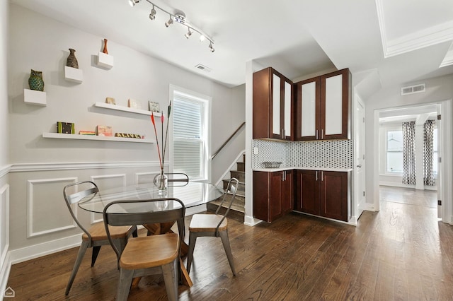 2314 N Mango Ave, Chicago, IL 60639 - dining space with dark wood-type flooring, wainscoting, rail lighting, and stairs