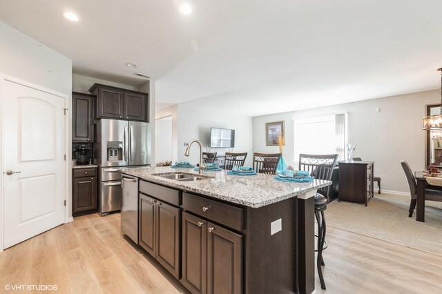 1029 Carolina Ct, Pingree Grove, IL 60140 - kitchen featuring appliances with stainless steel finishes, a breakfast bar, dark brown cabinetry, and recessed lighting