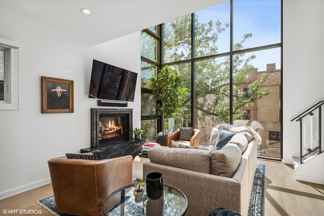 1547 N Wood St Unit 2, Chicago, IL 60622 - living room with a wall of windows, plenty of natural light, a fireplace, wood finished floors, and recessed lighting