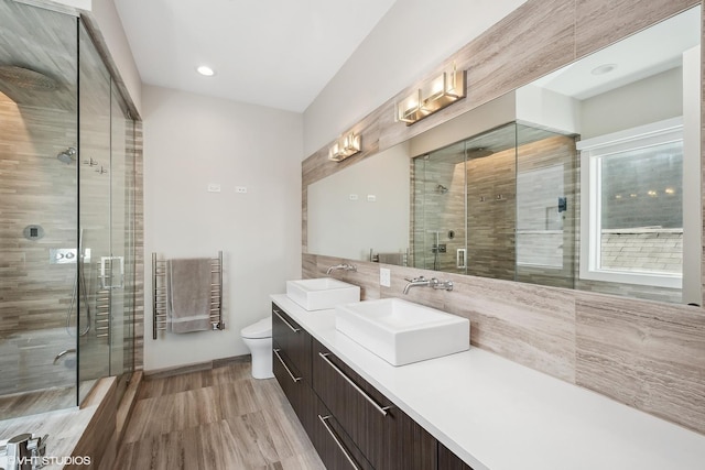 1547 N Wood St Unit 2, Chicago, IL 60622 - full bath with a shower stall, vanity, a towel warmer, wood finished floors, and recessed lighting