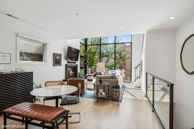1547 N Wood St Unit 2, Chicago, IL 60622 - living area featuring floor to ceiling windows, light wood-type flooring, a glass covered fireplace, and recessed lighting