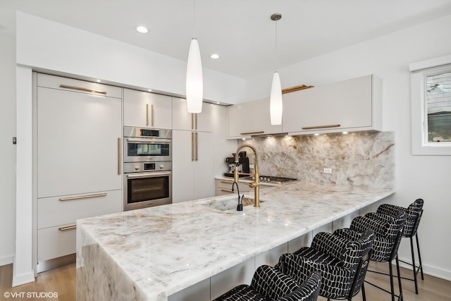 1547 N Wood St Unit 2, Chicago, IL 60622 - kitchen with double oven, a peninsula, white cabinets, tasteful backsplash, and recessed lighting