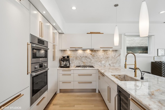 1547 N Wood St Unit 2, Chicago, IL 60622 - kitchen with beverage cooler, modern cabinets, stainless steel appliances, recessed lighting, and light wood finished floors