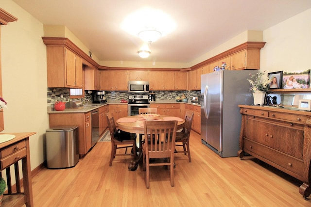 420 W N St, Bradley, IL 60915 - kitchen featuring appliances with stainless steel finishes, light wood-style flooring, decorative backsplash, and light countertops