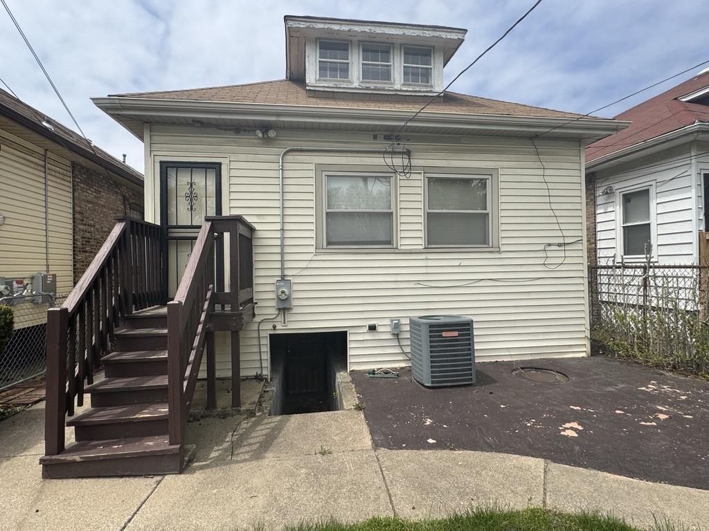 7649 S Michigan Ave, Chicago, IL 60619 - back of house featuring roof with shingles