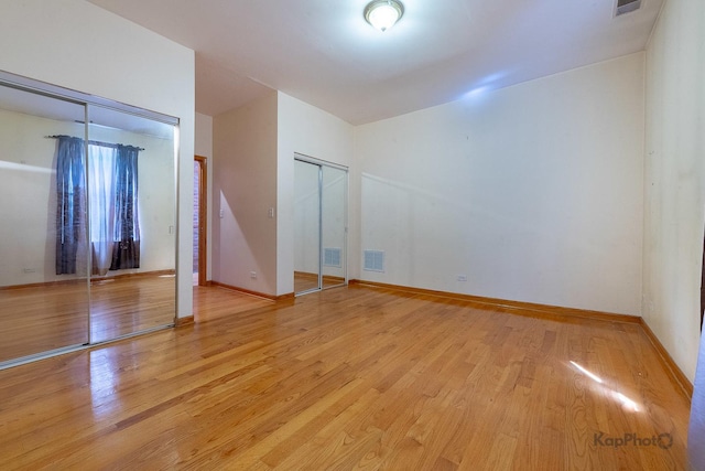 4137 S Prairie Ave Unit 3, Chicago, IL 60653 - unfurnished bedroom featuring light wood-style flooring and two closets