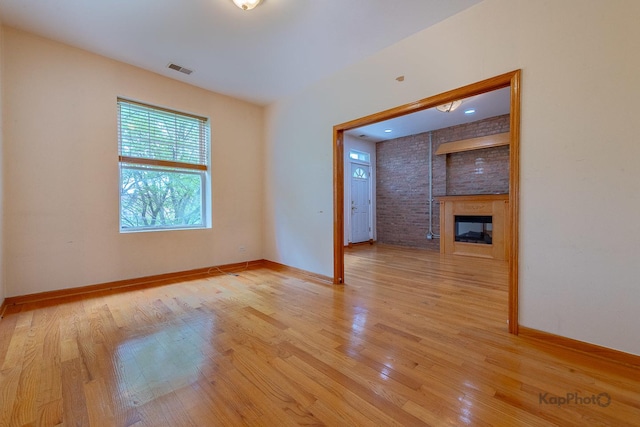 4137 S Prairie Ave Unit 3, Chicago, IL 60653 - unfurnished living room featuring light wood-style flooring and a large fireplace