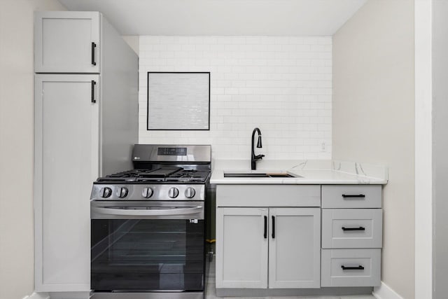 422 Locust St, Elgin, IL 60123 - kitchen with stainless steel gas stove, light countertops, and tasteful backsplash