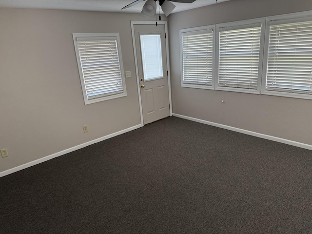 602 River Ln, Loves Park, IL 61111 - spare room featuring ceiling fan and dark colored carpet