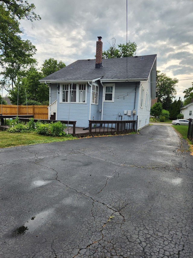 661 S Swain Ave, Elmhurst, IL 60126 - view of front of property featuring a chimney, a shingled roof, and a deck