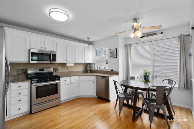 25 Cedar Ct, South Elgin, IL 60177 - kitchen featuring stainless steel appliances, white cabinetry, a ceiling fan, light wood finished floors, and decorative light fixtures