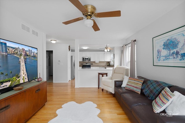 25 Cedar Ct, South Elgin, IL 60177 - living room with ceiling fan and light wood-style floors