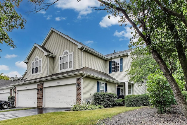 1996 Blackberry Ln, Hoffman Estates, IL 60169 - traditional-style house featuring a garage, driveway, brick siding, and a front yard