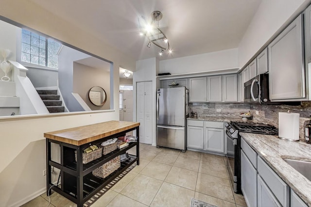 1996 Blackberry Ln, Hoffman Estates, IL 60169 - kitchen featuring appliances with stainless steel finishes, gray cabinets, backsplash, light tile patterned floors, and light stone countertops