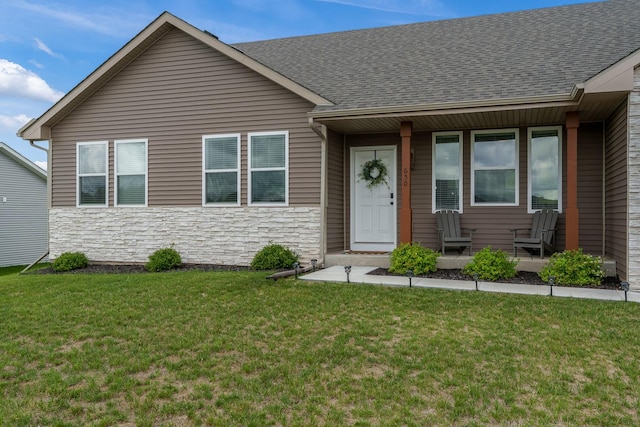 650 Anacostia Dr, Roscoe, IL 61073 - view of front facade with stone siding, covered porch, a front lawn, and roof with shingles