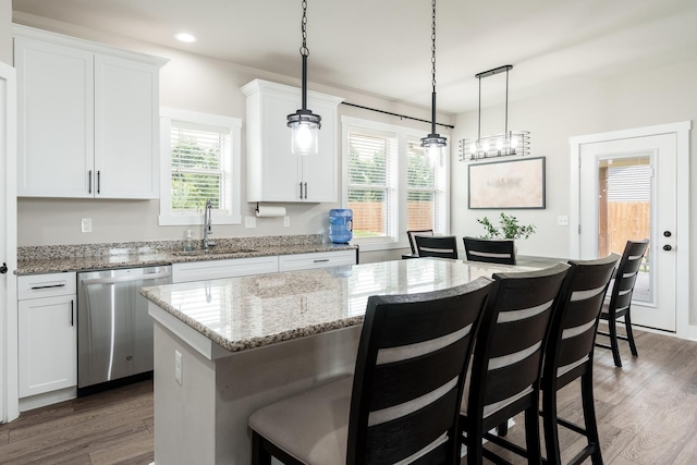 650 Anacostia Dr, Roscoe, IL 61073 - kitchen featuring dishwasher, wood finished floors, a breakfast bar, and recessed lighting