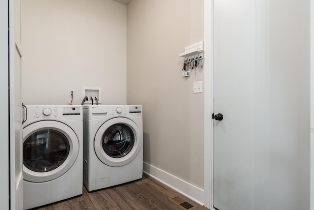 650 Anacostia Dr, Roscoe, IL 61073 - laundry room featuring washer and dryer and dark wood-style flooring