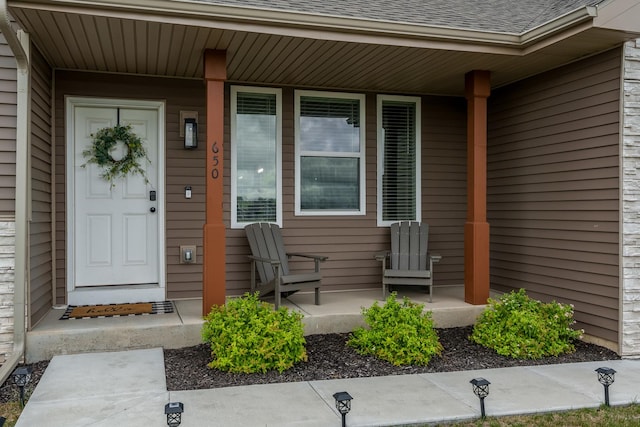 650 Anacostia Dr, Roscoe, IL 61073 - doorway to property with covered porch and roof with shingles