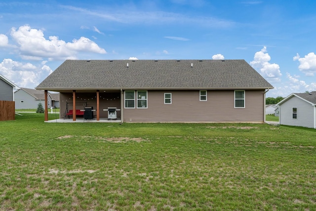 650 Anacostia Dr, Roscoe, IL 61073 - rear view of house featuring a patio area, a yard, and roof with shingles