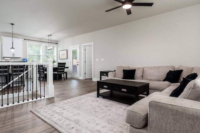 650 Anacostia Dr, Roscoe, IL 61073 - living room featuring wood finished floors, a ceiling fan, and a chandelier