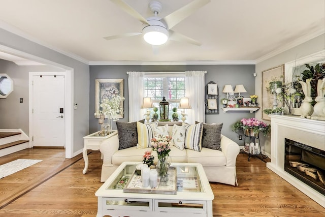 346 Colonial Cir, Geneva, IL 60134 - living area with ornamental molding, stairs, ceiling fan, light wood-style floors, and a glass covered fireplace