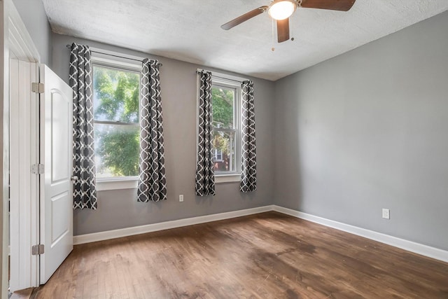 2630 S Spaulding Ave, Chicago, IL 60623 - unfurnished room with wood finished floors, plenty of natural light, ceiling fan, and a textured ceiling