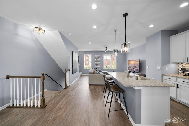 875 Finley Dr, Aurora, IL 60504 - kitchen featuring open floor plan, dark wood-style flooring, white cabinets, recessed lighting, and an island with sink