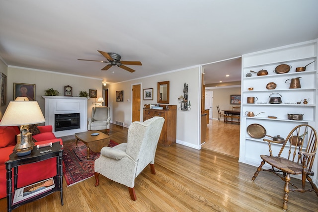 114 Kansas St, Geneva, IL 60134 - living room featuring wood finished floors, ceiling fan, crown molding, and a glass covered fireplace