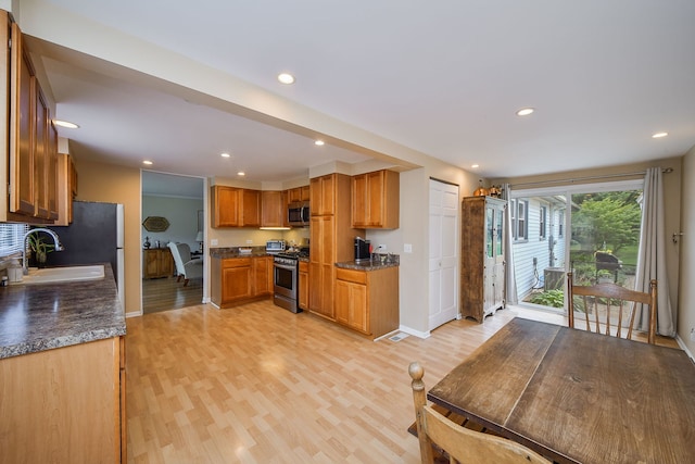 114 Kansas St, Geneva, IL 60134 - kitchen featuring appliances with stainless steel finishes, light wood-style floors, recessed lighting, and brown cabinets
