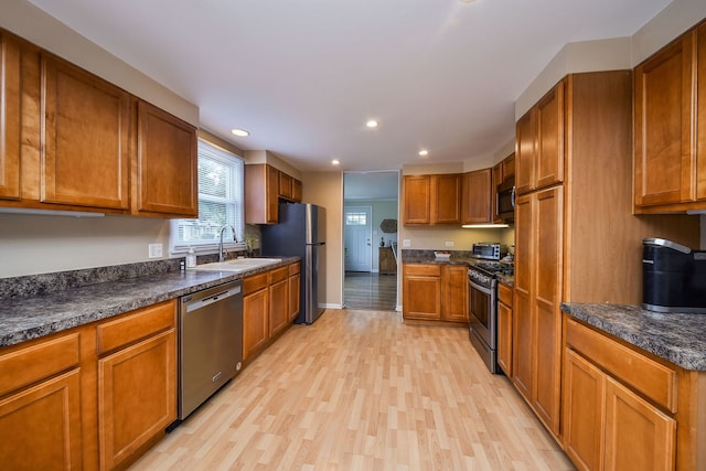114 Kansas St, Geneva, IL 60134 - kitchen featuring appliances with stainless steel finishes, brown cabinets, light wood-style flooring, and recessed lighting
