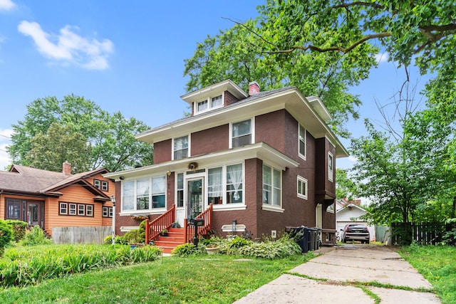 512 Ryerson Ave, Elgin, IL 60123 - american foursquare style home featuring a chimney and brick siding
