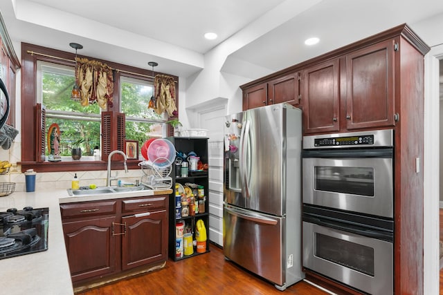 512 Ryerson Ave, Elgin, IL 60123 - kitchen featuring appliances with stainless steel finishes, light countertops, decorative backsplash, dark wood-style floors, and pendant lighting