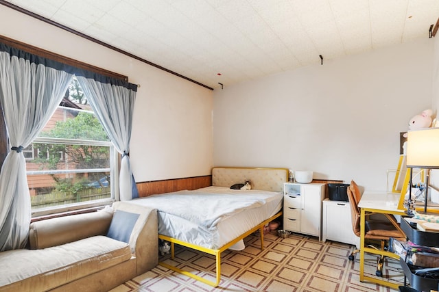 512 Ryerson Ave, Elgin, IL 60123 - bedroom with light flooring, a wainscoted wall, a desk, and wooden walls