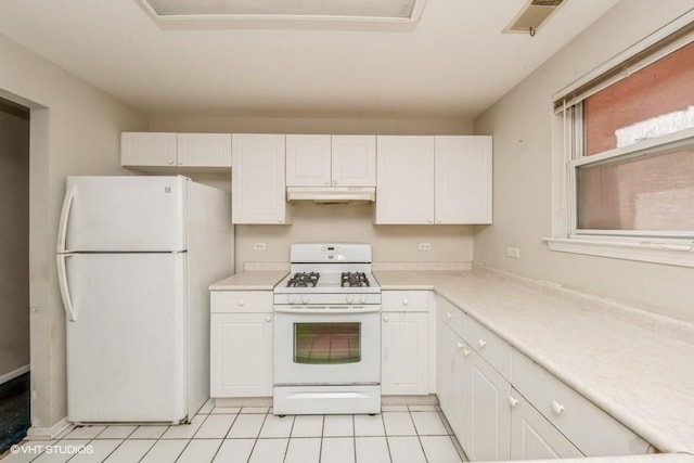 1465 N Larrabee St Unit B, Chicago, IL 60610 - kitchen with white appliances, white cabinetry, light countertops, under cabinet range hood, and light tile patterned floors