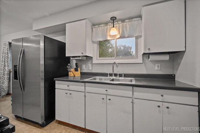 508 E Park St, Plano, IL 60545 - kitchen featuring dark countertops, stainless steel fridge, white cabinets, and pendant lighting
