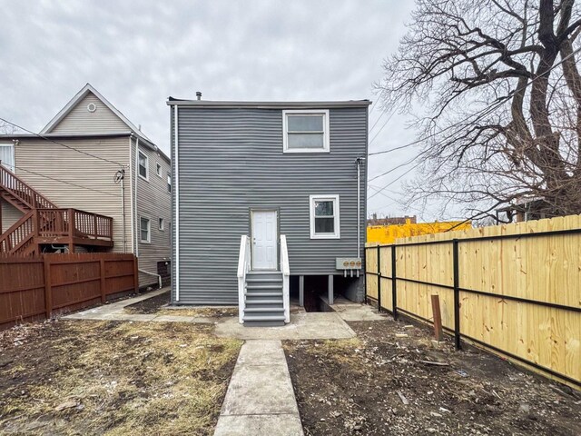 5915 S Sangamon St, Chicago, IL 60621 - back of house featuring entry steps and a fenced backyard