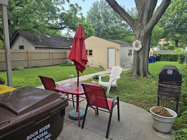 1524 Greenwood Ave, Rockford, IL 61107 - fenced backyard featuring a patio area, an outdoor structure, area for grilling, and outdoor dining space