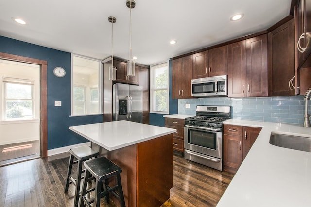 3029 N Haussen Ct, Chicago, IL 60618 - kitchen with stainless steel appliances, dark wood finished floors, decorative backsplash, and recessed lighting