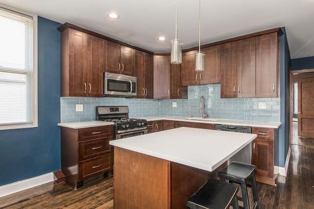 3029 N Haussen Ct, Chicago, IL 60618 - kitchen with stainless steel appliances, dark wood-style floors, light countertops, decorative backsplash, and a kitchen island