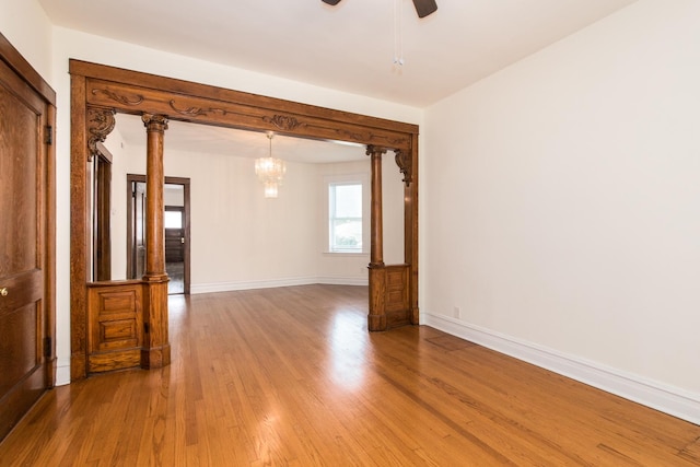 3029 N Haussen Ct, Chicago, IL 60618 - empty room featuring light wood-type flooring, a chandelier, and a ceiling fan