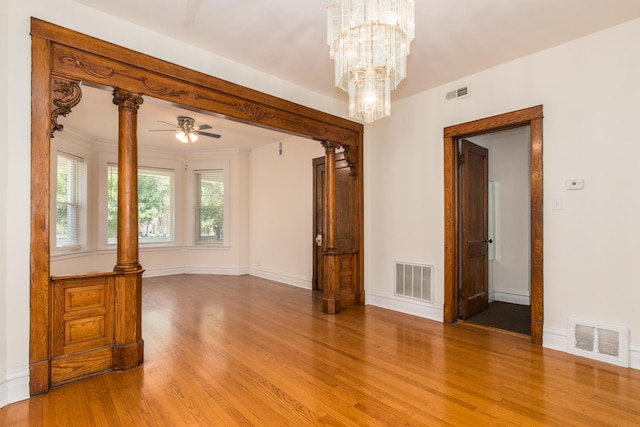 3029 N Haussen Ct, Chicago, IL 60618 - unfurnished room featuring light wood-style floors, a ceiling fan, and a chandelier