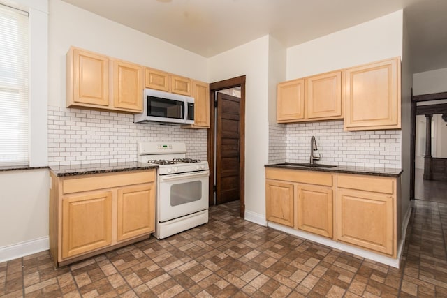 3029 N Haussen Ct, Chicago, IL 60618 - kitchen with white range with gas stovetop, light brown cabinets, and brick patterned flooring