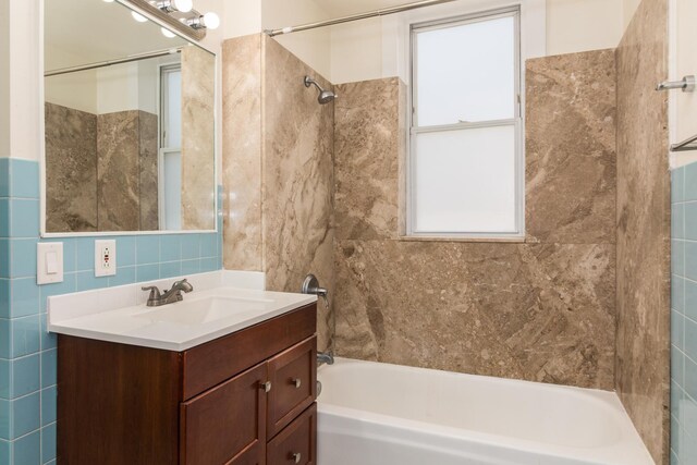 3029 N Haussen Ct, Chicago, IL 60618 - bathroom with tile walls, washtub / shower combination, and vanity