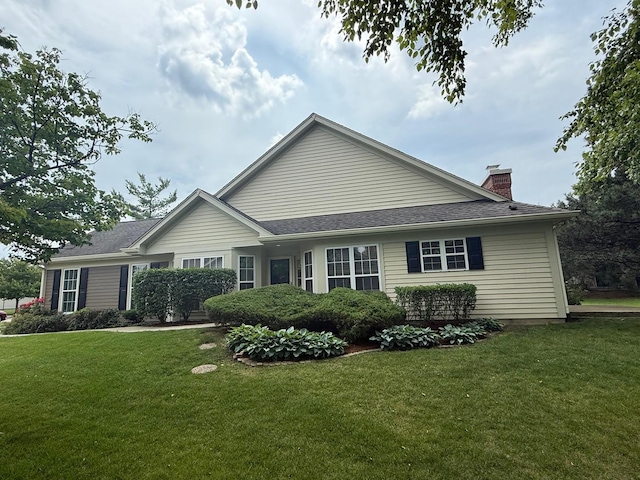 36138 N Springbrook Ln Unit 36138, Gurnee, IL 60031 - view of side of home with a lawn, a chimney, and a shingled roof