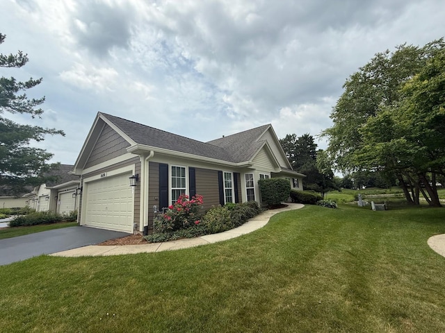 36138 N Springbrook Ln Unit 36138, Gurnee, IL 60031 - view of side of property with asphalt driveway, a lawn, an attached garage, and roof with shingles