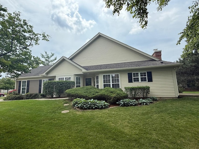 36138 N Springbrook Ln Unit 36138, Gurnee, IL 60031 - view of home's exterior with a lawn, a chimney, and a shingled roof