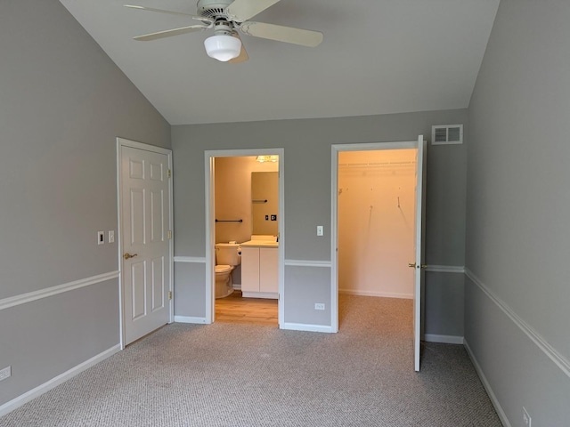 36138 N Springbrook Ln Unit 36138, Gurnee, IL 60031 - unfurnished bedroom featuring vaulted ceiling, carpet floors, a spacious closet, connected bathroom, and ceiling fan