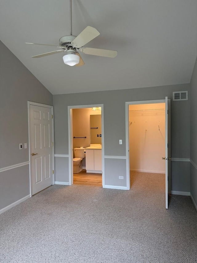 36138 N Springbrook Ln Unit 36138, Gurnee, IL 60031 - unfurnished bedroom with lofted ceiling, carpet flooring, a walk in closet, ensuite bathroom, and a closet