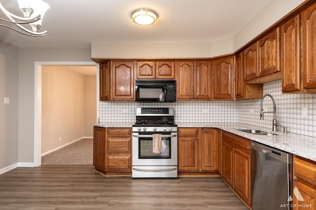 8226 Bob O Link Rd, Orland Park, IL 60462 - kitchen featuring stainless steel appliances, light stone countertops, brown cabinets, backsplash, and dark wood-style flooring