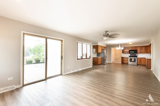 8226 Bob O Link Rd, Orland Park, IL 60462 - unfurnished living room with dark wood-style floors, a chandelier, and ceiling fan